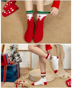 Close-up of thick coral fleece Christmas socks featuring reindeer and snowflake patterns