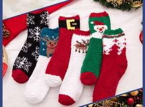 Detail view of five pairs of festive coral fleece Christmas socks with holiday patterns