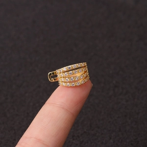 Gold multi-layer ear cuff with zircon rhinestones shown on a finger for size