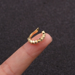Macro view of a petite gold-tone ear cuff with micro-pave crystals and beaded edges