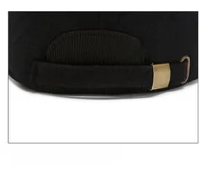 Macro detail of wool baseball cap back showing adjustable bronze metal buckle and strap