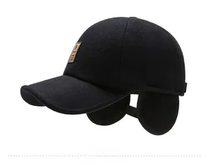 Detail view of winter baseball cap with foldable ear flaps and leather sport patch