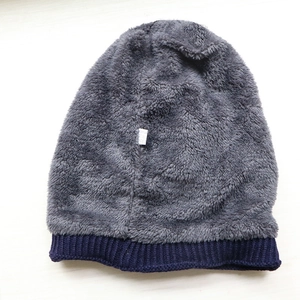 Close-up of the grey fleece lining and navy knit trim of the warm winter beanie