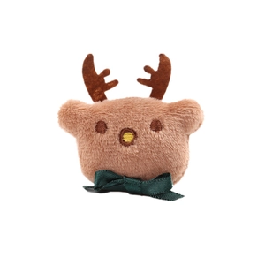 Plush Christmas reindeer brooch accessory with a green bow on a clean white background