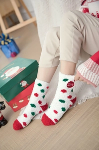 Detail of soft coral fleece Christmas sock with JOY embroidery and red polka dots on white