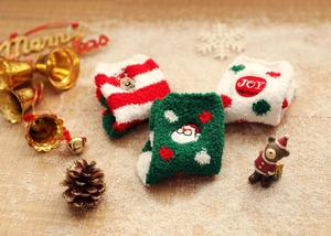 Detailed view of festive coral fleece Christmas socks with festive embroidery and motifs