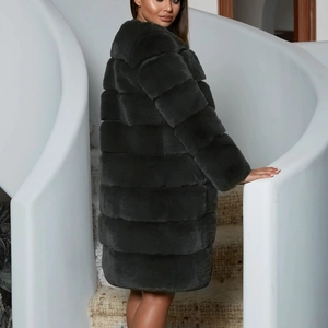 Detail view of the plush texture and layered design on a grey long faux fur coat for women