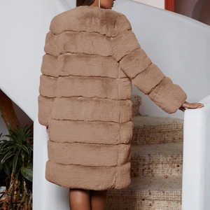 Detail of long brown faux fur coat showing horizontal tiered stitching and rich texture