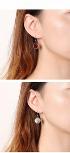 Close-up of square zircon earrings in red and clear tones with silver-tone settings
