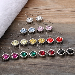 Square multicolor zircon earrings set in steel finish displayed on a wooden surface