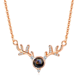 Rose gold antler necklace featuring 100 languages I love you projection stone and crystals