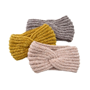 Detailed knit texture of three twist winter headbands in yellow, purple, and pink chenille