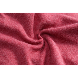 Close-up of the soft red knit fabric texture and warm thermal material of the beanie hat