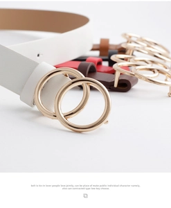 Close-up of slim white belt with golden double ring buckle and colorful belt selection