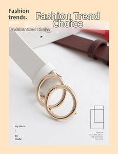 Detail of vintage double-circle gold buckle on stylish leather belt for women