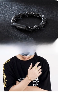Detail of matte black and gold curb chain bracelets for men with durable box clasps