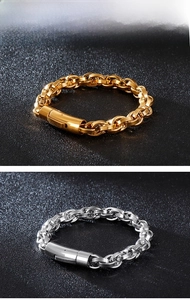 Detail of silver and gold woven link chains with cylindrical clasp on black background
