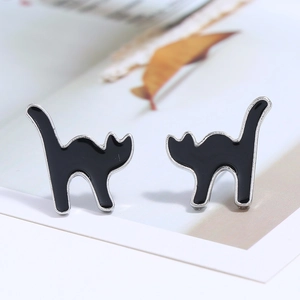 Close-up of black enamel cat stud earrings with creative arched back design