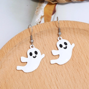 Detailed macro view of white ghost resin drop earrings on a light wooden tray
