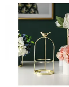 Detailed view of elegant gold metal bird frame for desktop jewelry or floral display