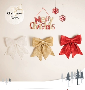 Close-up of three glitter Christmas bows in white, gold, and red for tree decoration