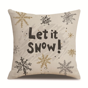 Detail of linen Christmas pillowcase with snowflake patterns and 'Let it SNOW!' text