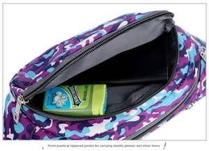 Detail view of camouflage waist bag showing internal capacity for phone and daily items