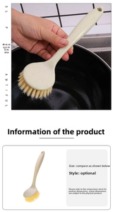 Detailed view of wheat straw kitchen brush with long handle cleaning a black frying pan
