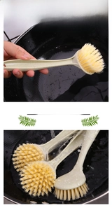 Macro detail of long-handle dish brush with stiff nylon bristles cleaning a black wok