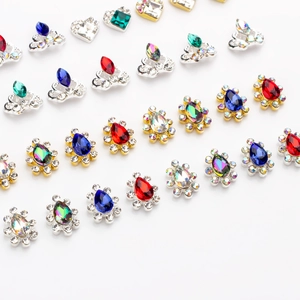 Flat lay of alloy nail art charms with colorful K9 rhinestones in assorted shapes