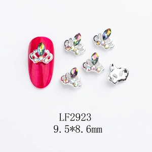 Silver crown nail charms with colorful rhinestones shown on red manicure and loose pieces
