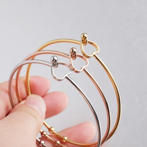 Minimalist stainless steel open bangles with heart charms in gold, silver, and rose gold