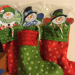 Detail of Christmas stocking gift sets featuring snowman plush toys and candy canes