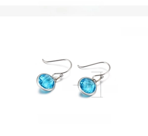 Detailed macro view of 11mm sea blue faceted glass drop earrings in stainless steel