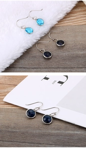 Detailed view of titanium steel hook earrings with blue and navy faceted stones