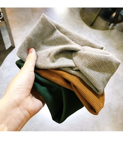 Detail shot of elastic ribbed knit headbands in light grey, dark green and mustard yellow