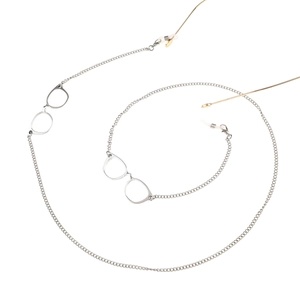 Detail of silver metal eyewear chain with golden accents and decorative glasses pendant