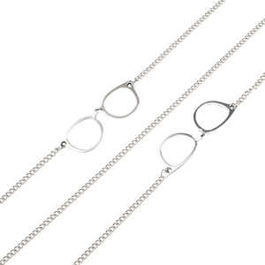 Macro detail of anti-slip silver metal eyewear chain with stylish glasses-shaped pendants
