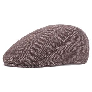 Detail of tan herringbone newsboy cap showing premium wool-like fabric texture and stitch