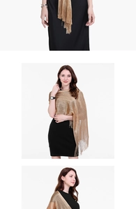 Detail of elegant gold sequined evening shawl with tassels over a black dress