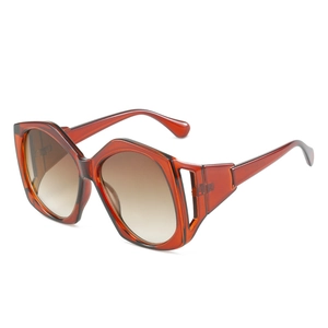 Modern oversized geometric amber sunglasses with stylish hollow temples and brown lenses