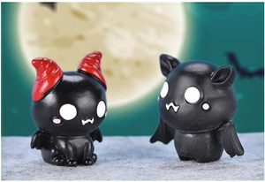 Close-up of cute cartoon black bat figurines with red horns for Halloween decor