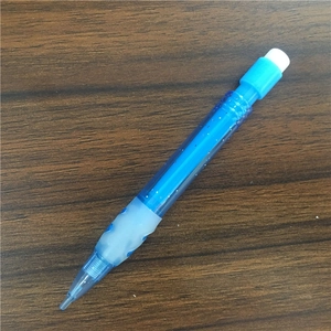 Detailed top view of a mini blue mechanical pencil with eraser on a wooden desk surface