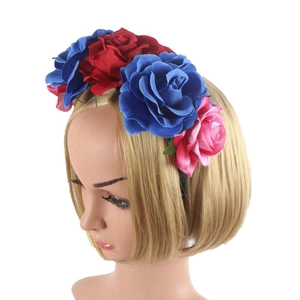 Detail of floral headband with blue red and pink roses on a model with blonde hair