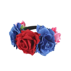 Detailed macro view of vibrant red and deep blue velvet roses on a festive flower headband