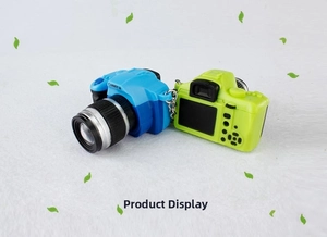 Detailed view of blue and green mini toy camera keychains with LED sound features