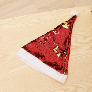 Macro detail of red and gold reversible sequins on a plush Christmas reindeer antler hat