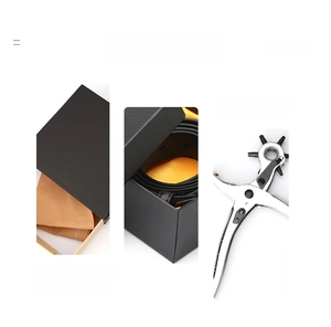 Detailed view of black textured belt with yellow satin gift box and silver hole puncher tool