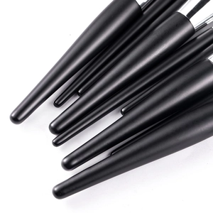 Close-up of matte black handles and polished silver ferrules on makeup brush set