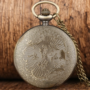 Detail of vintage bronze pocket watch with phoenix flower relief and antique chain